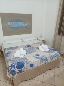 a bedroom with a bed with towels on it at ACasammare Apartment in Marsala