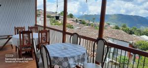 a table and chairs on a balcony with a view at Bonsai Hotel Salamina Caldas in Salamina