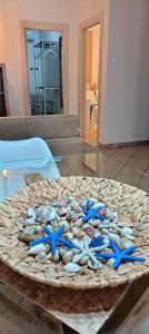 a table with blue starfish and shells on it at ACasammare Apartment in Marsala