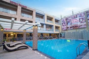 una grande piscina di fronte a un edificio di Royal Palace Beach Resort a Mandarmoni