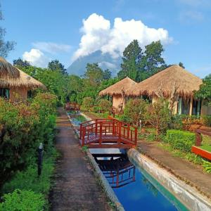 a river with some huts and some water at Aurora Resort Chiangdao in Chiang Dao