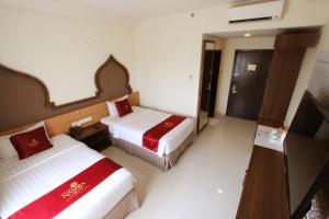 Ein Bett oder Betten in einem Zimmer der Unterkunft Namira Syariah Hotel Surabaya