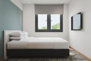 Postel nebo postele na pokoji v ubytování The Concept Hotel Melaka City