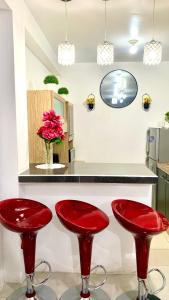 two red stools in a kitchen with a counter at Cusco Magico 9 - Loft Santa Ursula in Cusco