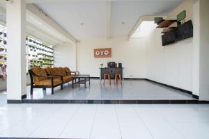 a room with chairs and a table in a building at SUPER OYO 3350 Cozy Residence Syariah in Malang