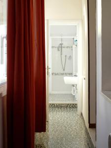 a bathroom with a sink and a toilet in a room at FiorDiLuna, nel cuore di Brescia in Brescia