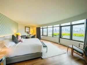 a bedroom with a large bed and a large window at Grand China Bangkok in Bangkok