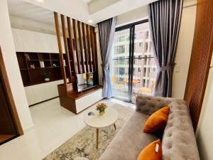 a living room with a couch and a table at OSIMI Apartment - 1 Bedroom - A0817 in Phú Mỹ