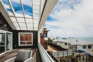 a balcony with a view of the ocean at Buller Noire Outstanding in New Plymouth