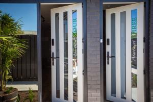 a pair of doors in front of a building at The Residence Apartment 9 50 Sky in New Plymouth