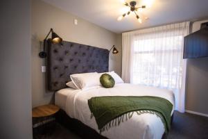 a bedroom with a large bed with a large window at The Residence Apartment 9 50 Sky in New Plymouth