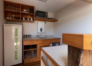 a kitchen with a sink and a refrigerator at The Eco Lodge Tsb Topec in Hillsborough