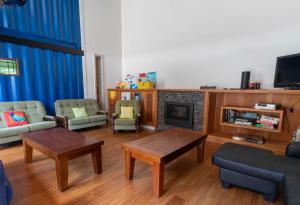 a living room with a couch and a fireplace at The Eco Lodge Tsb Topec in Hillsborough