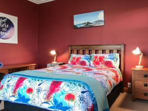 a bedroom with a bed with a colorful bedspread at The Brooklands Bungalow in New Plymouth