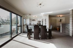 a kitchen and dining room with a table and chairs at Seven By The Sea Tourist Hot Spot in New Plymouth