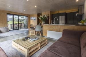 a living room with a couch and a coffee table at The Natural Home Prime Fitzroy Location in New Plymouth