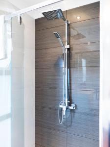 a shower with a glass door in a bathroom at Magic On Molesworth Wow Factor Prime Location in New Plymouth