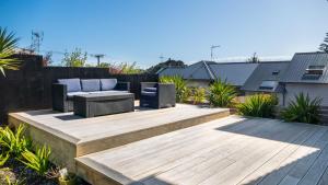 a patio with two chairs and a wooden deck at Magic On Molesworth Wow Factor Prime Location in New Plymouth