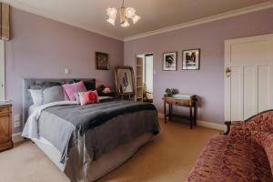 a bedroom with a large bed and a table at The lookout Central in New Plymouth