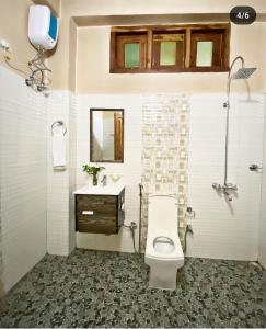 a bathroom with a toilet and a sink at Olive homestay in Kohīma