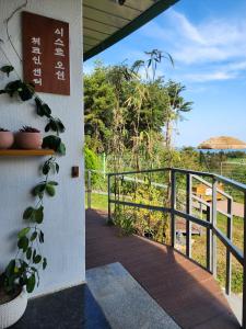 a walkway leading to a porch with a fence at Zio Pinetree in Yangyang