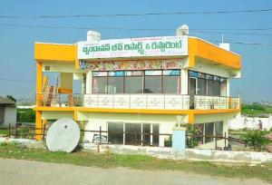 a building with a sign on the side of it at OYO BRINDAVAN BEACH RESORT & RESTAURANT 