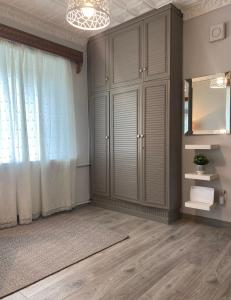 a living room with a large window and a mirror at 2 bedroom apartment close to Kaunas airport in Karmelava in Karmėlava