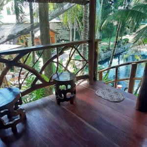 a balcony of a house with a view of the water at Dumaguete Treehouse in Dumaguete