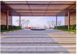 an empty parking lot with a large building at Royal Executive Apartment, Shenzhen World Exhibition & Convention Center, Nearby Shenzhen World North Metro St ation in Bao'an