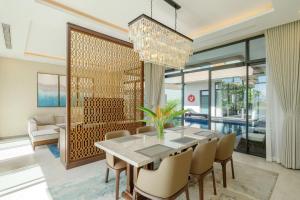 a dining room with a table and chairs at Residence Inn Villa Cam Ranh in Cam Ranh