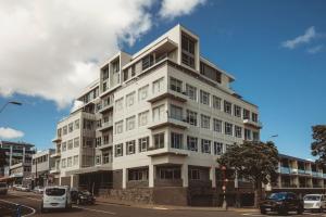 a tall white building on a city street at Liardet22 The Penthouse in New Plymouth