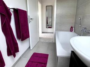 a bathroom with a white tub and a sink at Apartment mit Weitblick in Leppin +10 photos