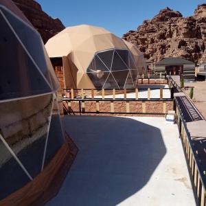 a view of a domed building with mountains in the background at غرووب وادي رم in Wadi Rum