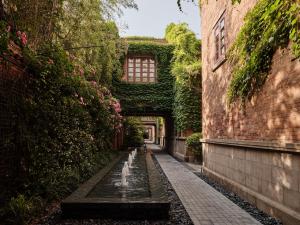 an alley in a building with a water fountain at Capella Shanghai, Jian Ye Li in Shanghai