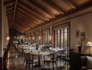 a dining room with tables and chairs and windows at Capella Shanghai, Jian Ye Li in Shanghai