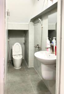 a bathroom with a toilet and a sink at Azalea Apartment in Hanoi