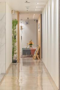 a hallway with a table and a chair in a building at Snowflower Guesthouse in Seoul