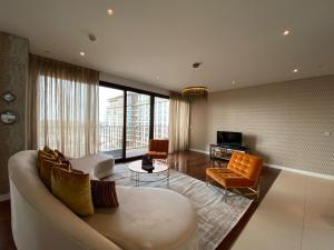 a living room with a couch and chairs and a television at Dream Inn Apartments - City Walk Prime in Dubai
