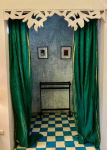 a room with green curtains and a checkered floor at The Backyard 28 in Khlong Toei