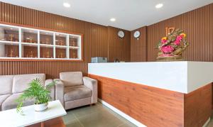 a lobby with a bar and a chair and a counter at Treebo Trend JP Residency in Trivandrum