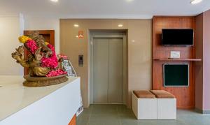 a lobby with a flower arrangement on a stair case at Treebo Trend JP Residency in Trivandrum
