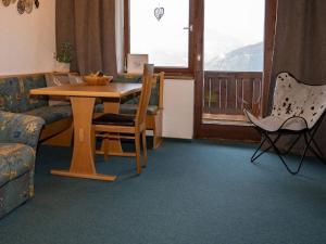 a living room with a table and a couch at Cosy holiday flat in Pinzgau in Bramberg am Wildkogel