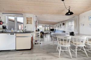 a kitchen and dining room with a table and chairs at Charming Cottage In Mesinge in Mesinge