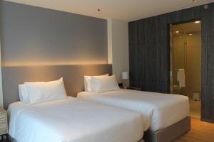two beds sitting next to each other in a hotel room at Wyndham La Vita Rawai Phuket in Rawai Beach