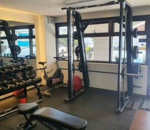 a gym with several treadmills and machines in a room at TamnaCounty L101 - DtreeSuite OceanVIew,B&B,BBQ,Pool in Seogwipo