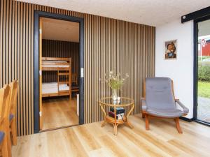 a room with a chair and a table and a bed at Holiday home Aabenraa LXXVII in Aabenraa