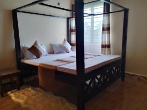 a bedroom with two bunk beds and a window at Blessing holiday homes - Diani Beach in Diani Beach