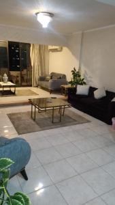 a living room with a couch and a coffee table at الدقى ميدان المساحه أمام فندق سفير in Cairo