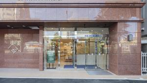a store front with glass doors in a building at Toyoko Inn Tokuyama-eki Kita-guchi in Shunan
