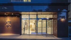 a store front with glass doors at night at Toyoko Inn Tokuyama-eki Kita-guchi in Shunan +34 photos